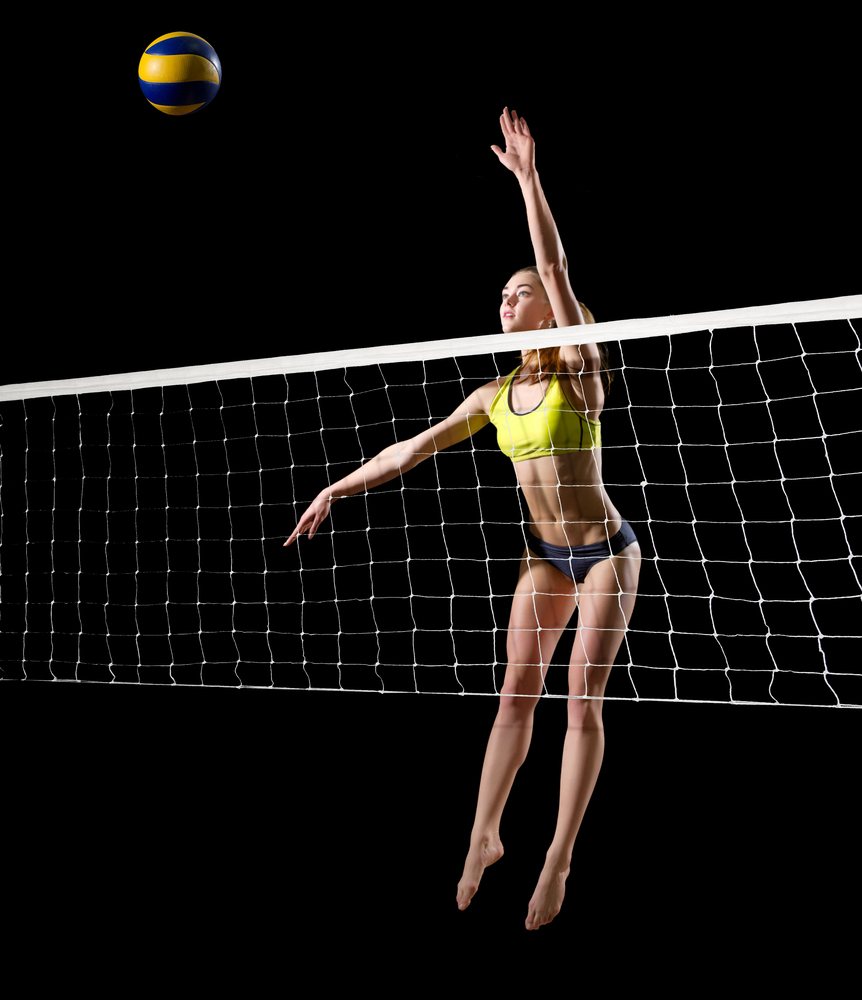 Young woman beach volleyball player (with ball and net version)