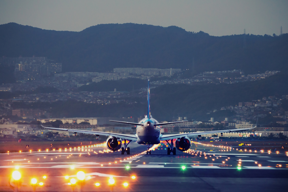 big plane landing at dusk at Osaka-Itami International Airport, Japan. big plane landing during blue hour