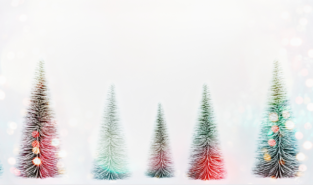 Decorative Christmas trees with sunshine bokeh on white background, banner or template. Fir trees forest