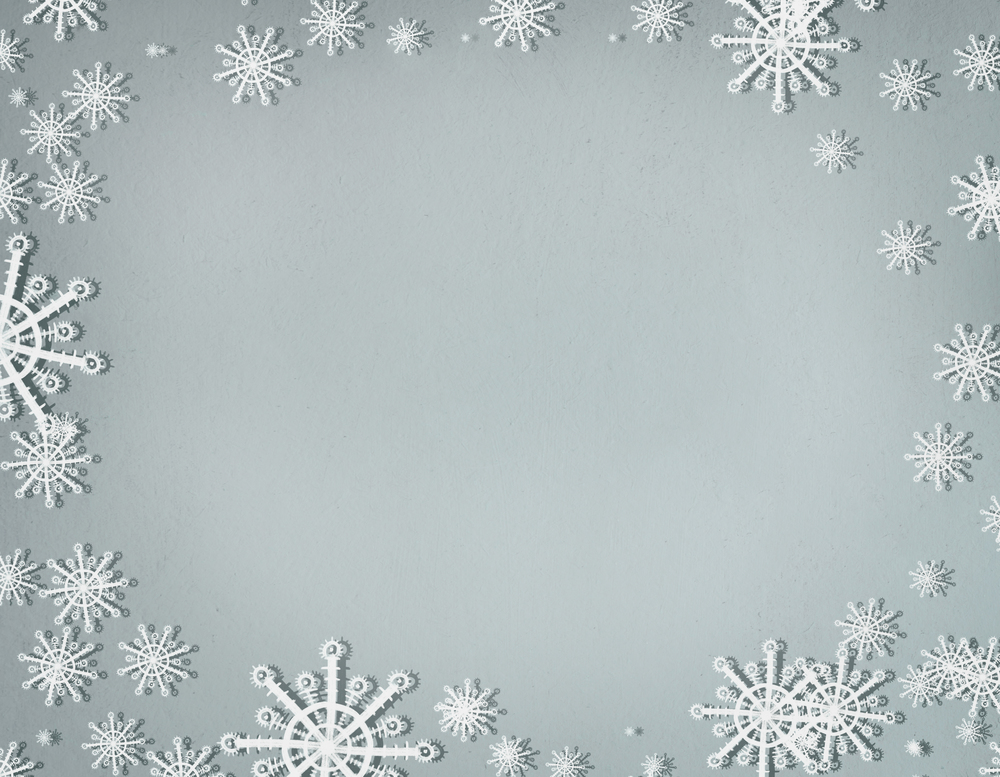 Snowflakes frame on cold gray background with copy space, top view. Christmas and winter holiday concept
