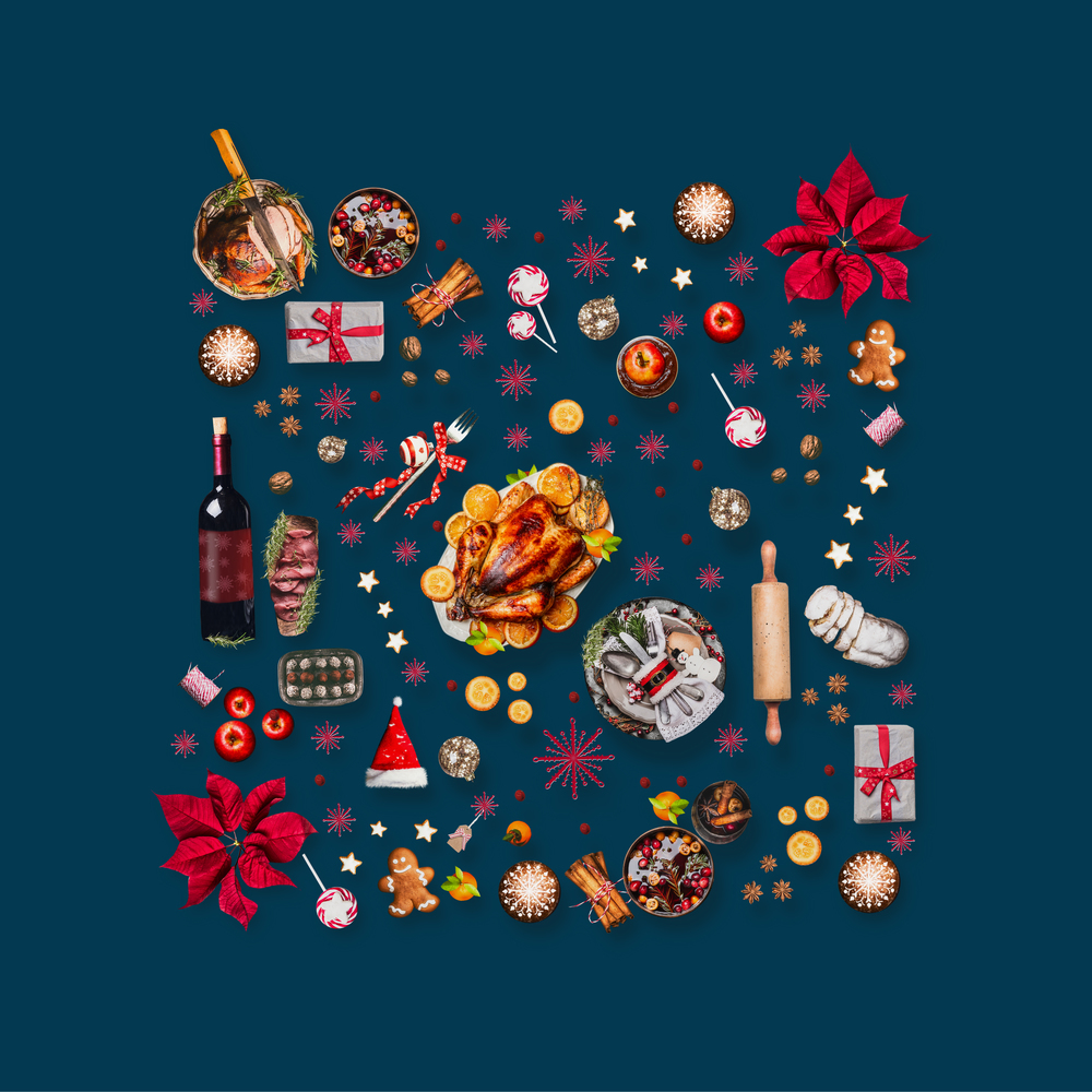 Various Christmas foods and red decoration for Christmas dinner. Composition pattern on dark blue background, top view