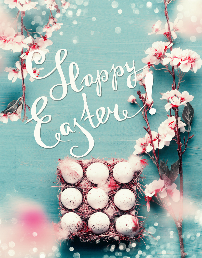 Beautiful Happy Easter greeting card with text lettering. Spring blossom branches frame and egg-crate with Easter eggs at blue background