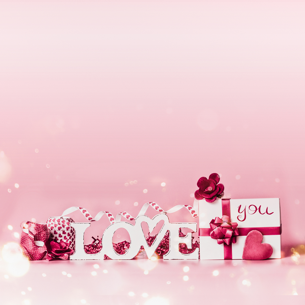 Valentines day background. Romantic composition with Love you message, gift box, red ribbons and hearts. Festive greeting concept. Love declaration concept. Copy space for your design. Border