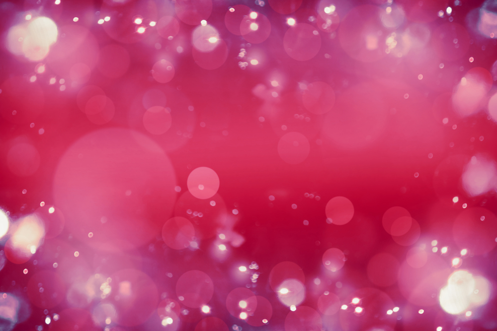 Bright pink red bokeh background. Blurred abstract holiday or event background.