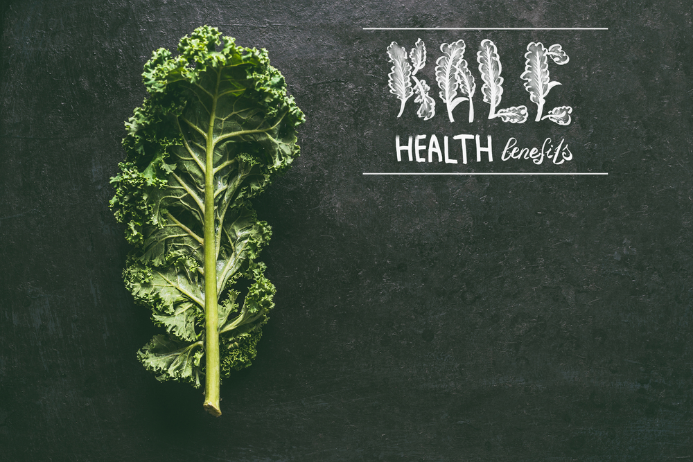 Kale health benefits background with fresh kale leaf. Healthy detox vegetables . Clean eating and dieting concept. Top view with copy space. Text lettering