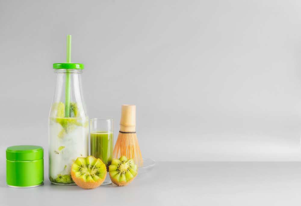 Healthy matcha espresso and iced matcha fusion latte in bottle with drinking straw and matcha tee in tin can. Antioxidant boost beverages. Detox and clean eating concept. Summer refreshing beverages