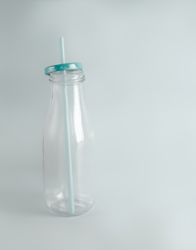 Empty bottle with eco friendly  glass drinking straw. Zero Waste concept.