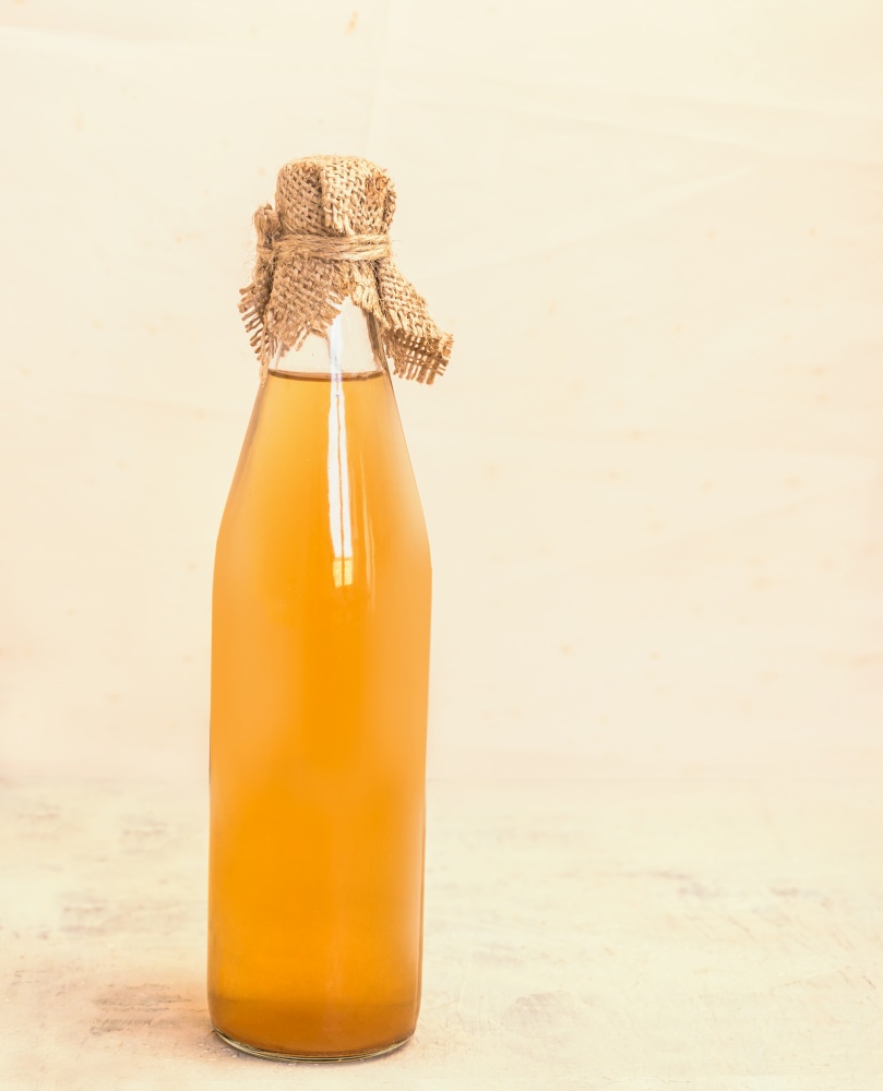 Bottle of homemade apple juice or vinegar on  kitchen table. Still life