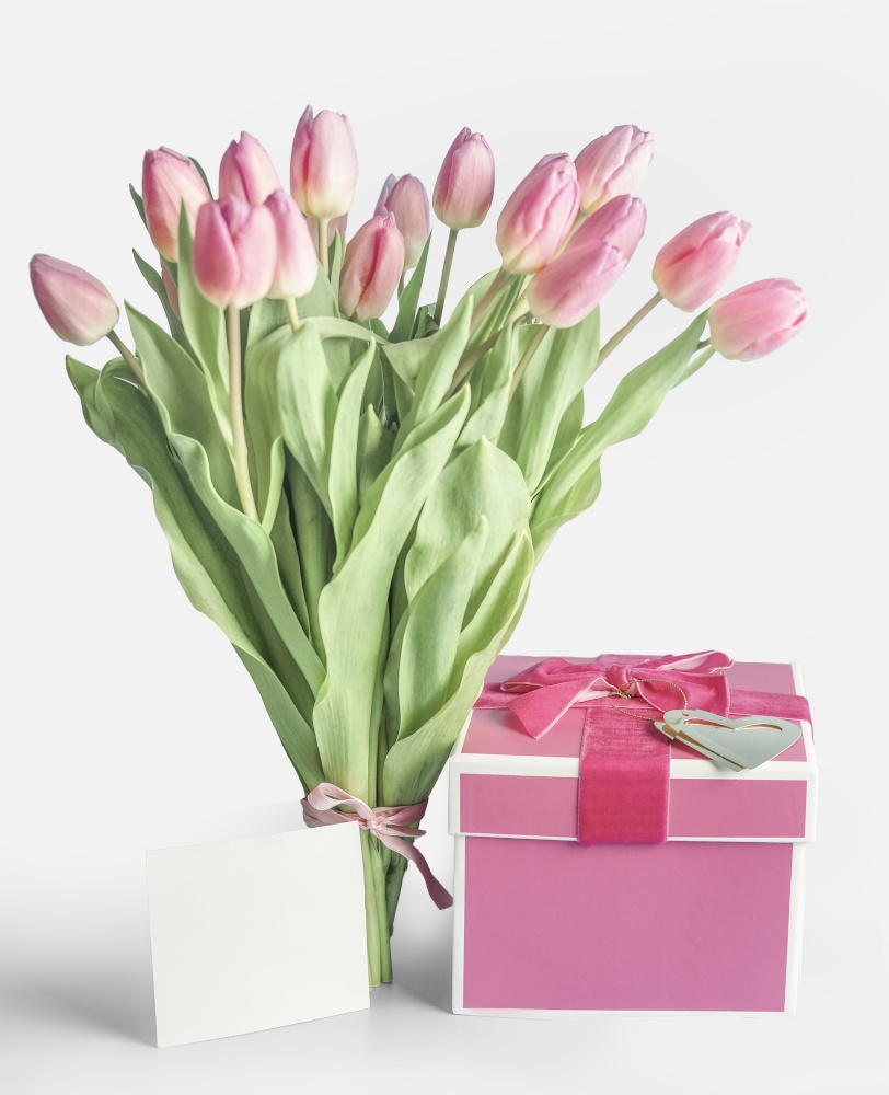 Lovely tulips bunch with pink gift box and blank greeting card at white background