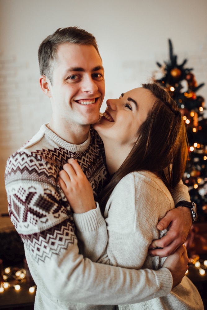 a guy and a girl celebrate the new year together
in a warm atmosphere and give each other gifts