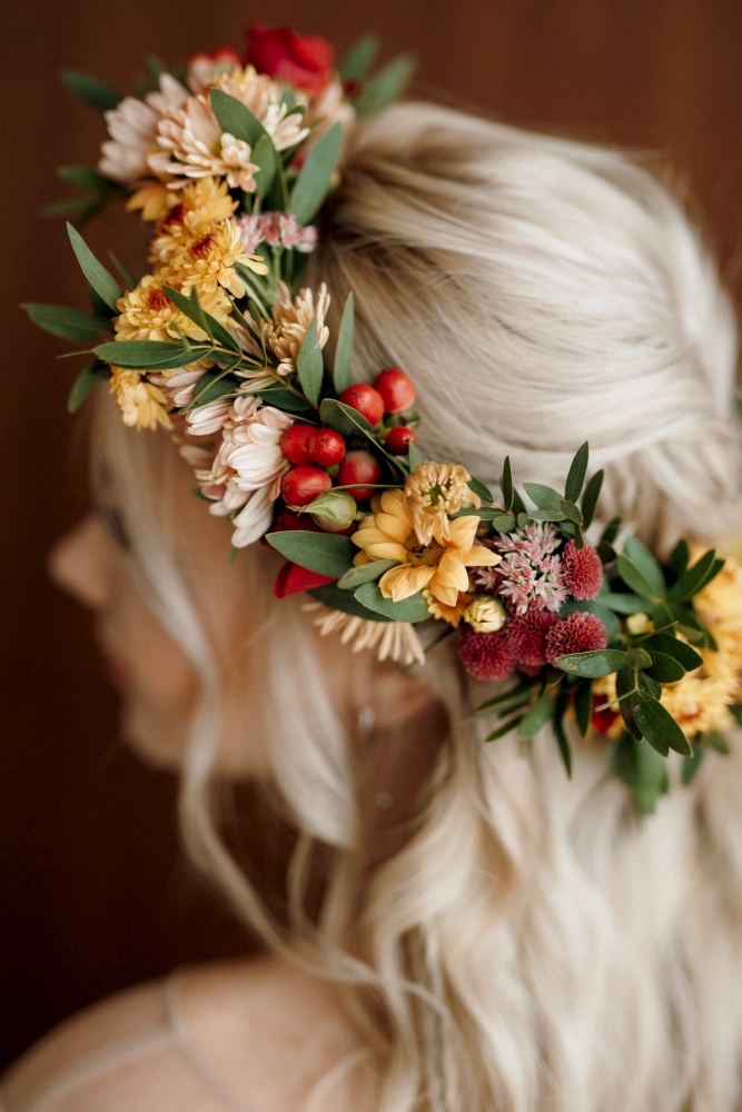 wedding wreath of dried flowers on the head of a bride with white hair