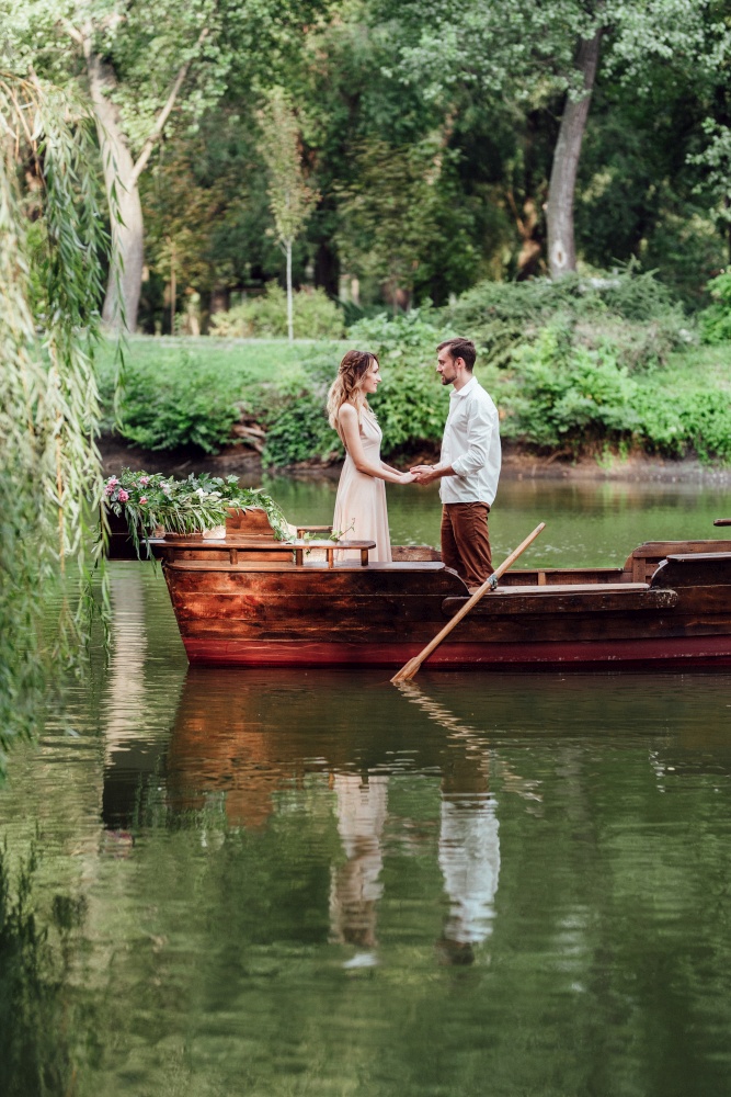 a boat trip for a guy and a girl along the canals and bays of the river overgrown with wild willows
