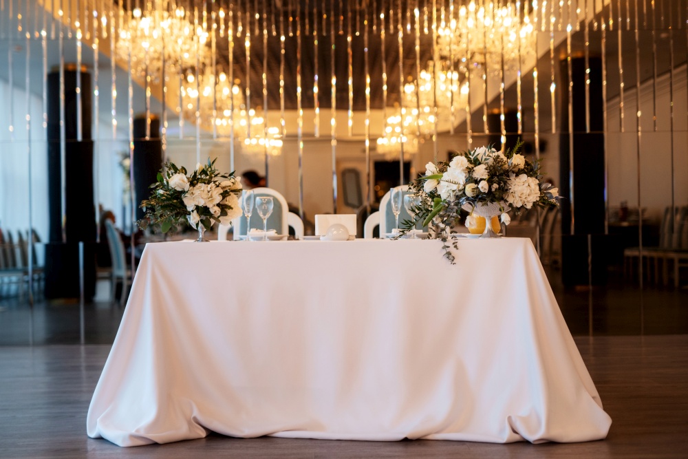 The presidium of the newlyweds in the banquet hall of the restaurant is decorated