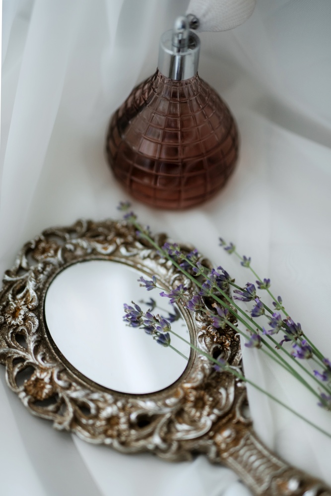 Perfume and a mirror at the morning gathering of the bride
