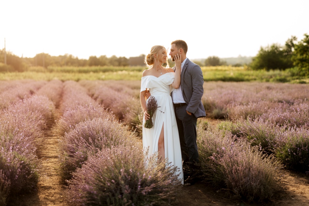 bride and groom on a walk in the lavender field