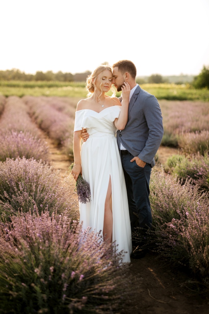 bride and groom on a walk in the lavender field