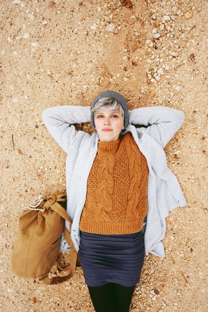 Young adventure woman lying on sand