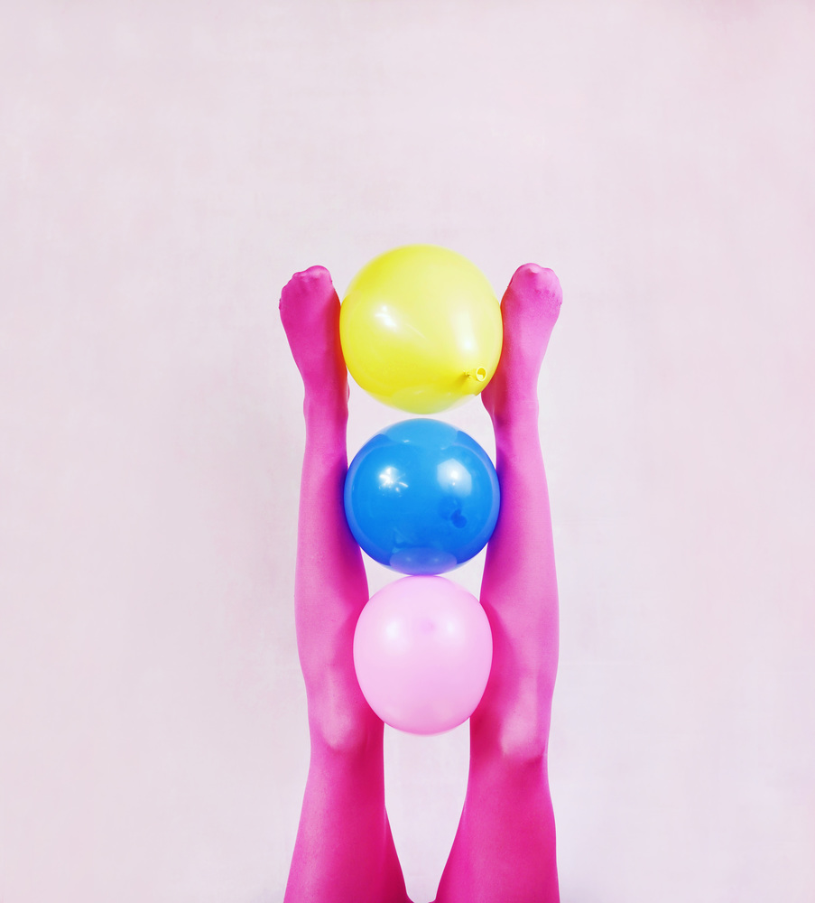 Pop art about legs wearing pink tights and holding balloons