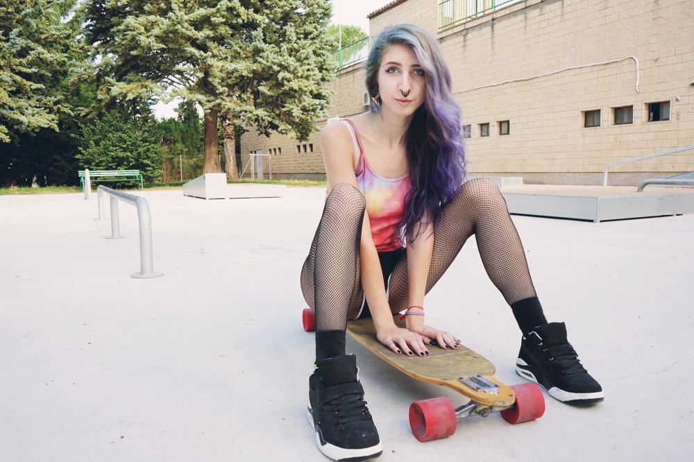 Teen skater woman enjoying the day at the skate park
