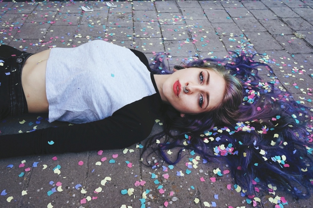Beautiful young woman surrounded by confetti