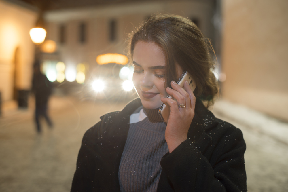 girl with phone in the evening city