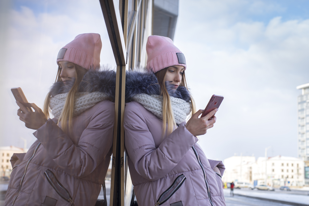 girl with phone in the city. Winter