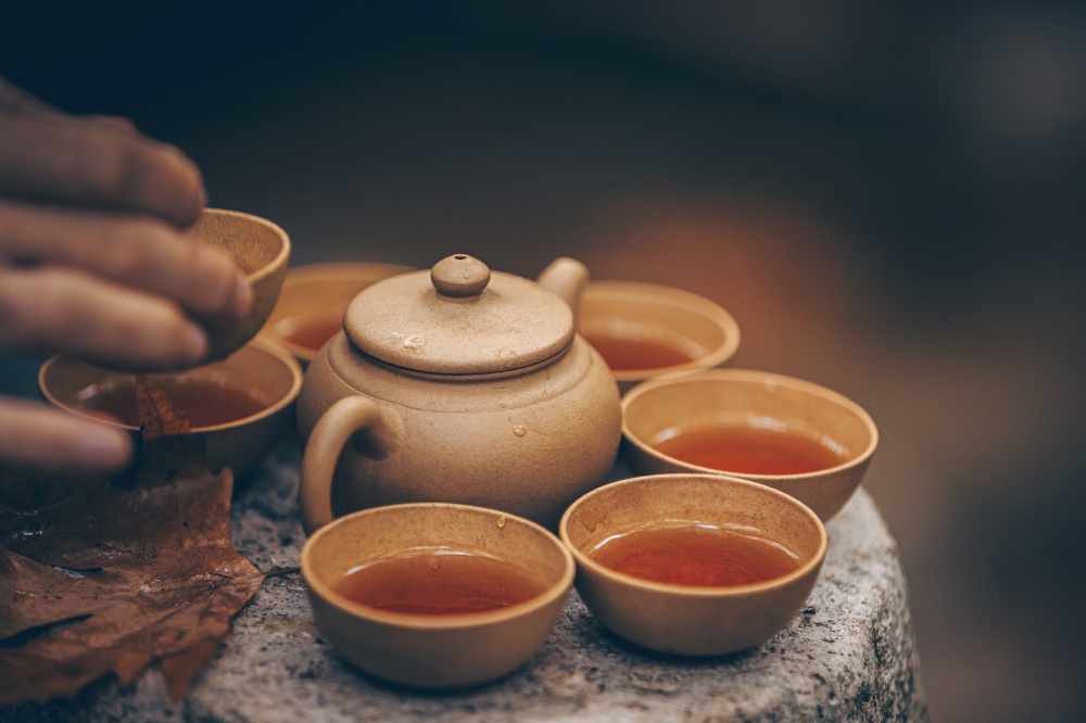 Enjoy the simplicity of tea pouring in a peaceful natural setting that invites serenity and connection with others. The Art of Ceremonial Tea Pouring Amidst the Beauty of Natures Scenic Landscapes