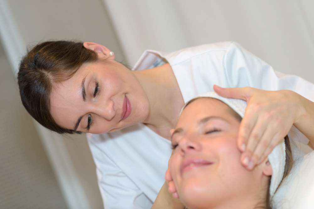 a woman is having a facial treatment