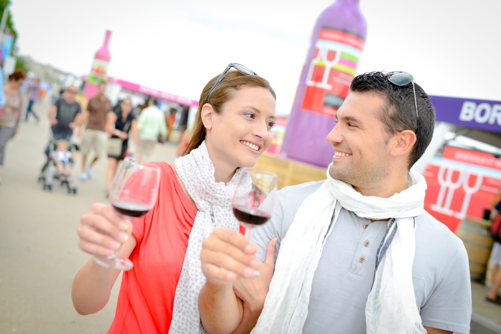 Couple holding glasses of red wine