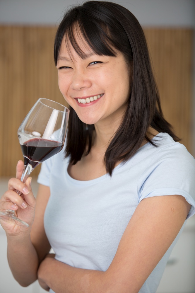 happy woman with a glass of red wine