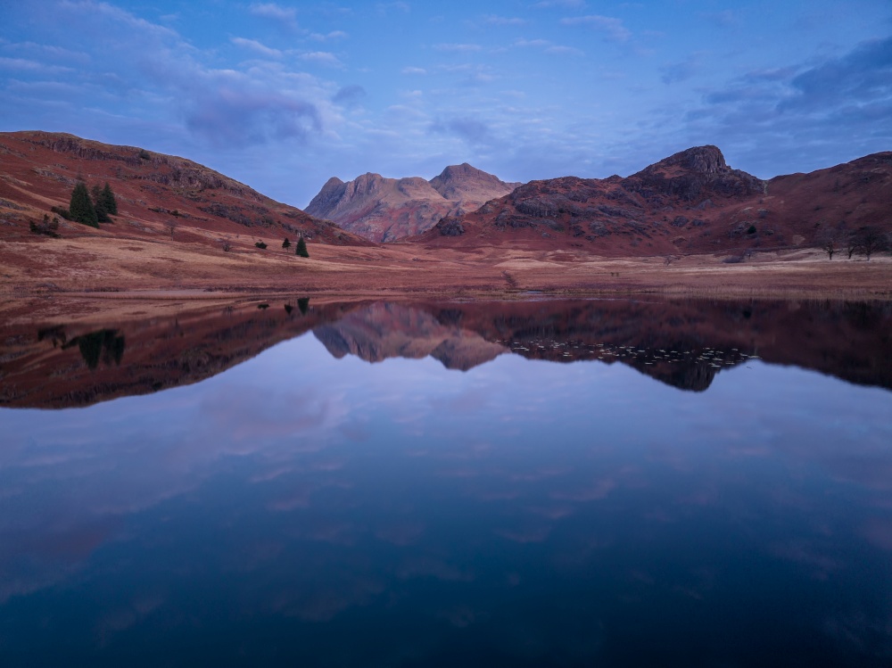 Beautiful atmospheric aerial drone Autumn landscape image of Langdale Pikes in Lake District