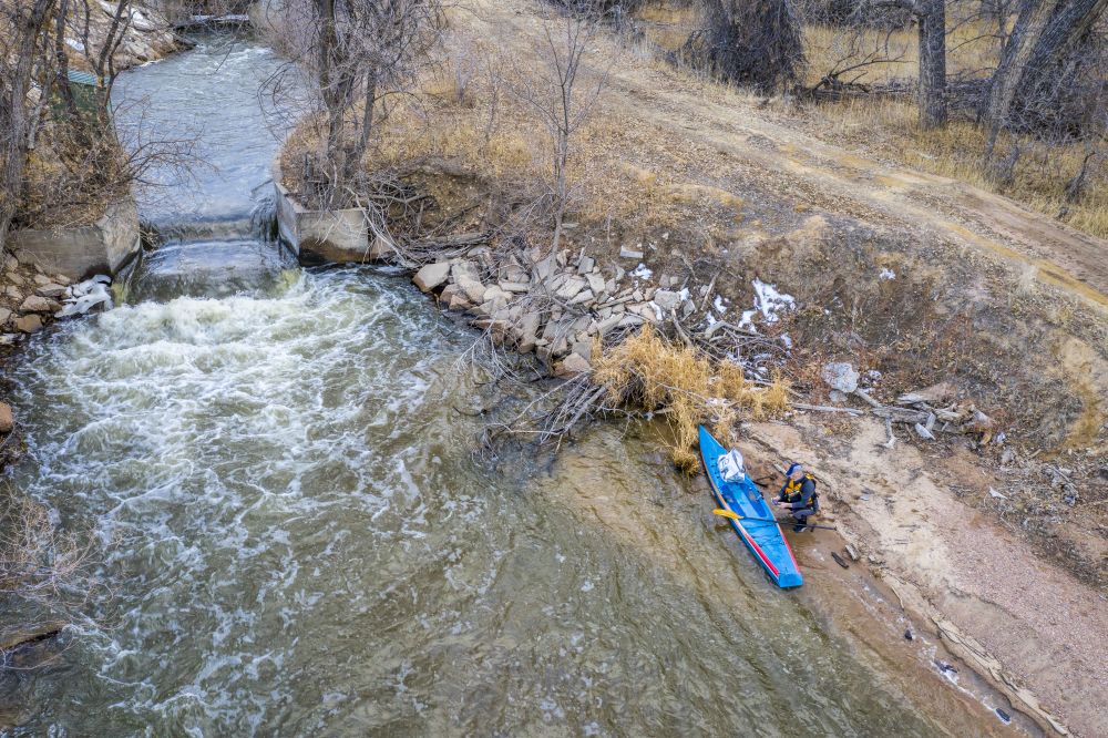 Stand up paddler on a shore of South Platte RIver at LaSalle, Colorado - aerial view