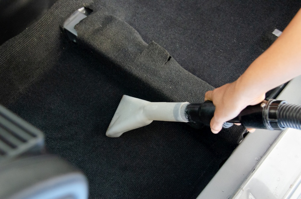 Wash the car carpet.Detailing on interior of modern car.Vacuum and clean the inside of the car.