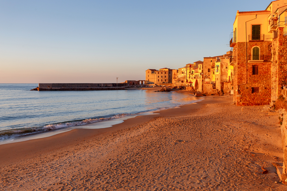City embankment in the old medieval town Cefalu at sunset. Italy. Sicily.. Cefalu. Sicily. Old city.