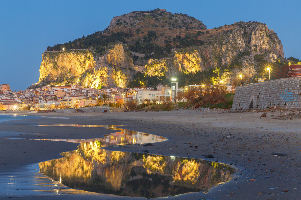 City embankment in the old medieval town Cefalu at sunset. Italy. Sicily.. Cefalu. Sicily. Old city.