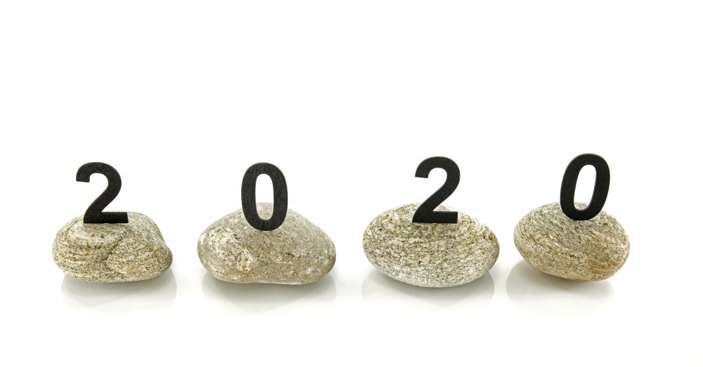 New years resolution 2020 concept, Wooden year number on stones isolated on white background with reflection and copy space