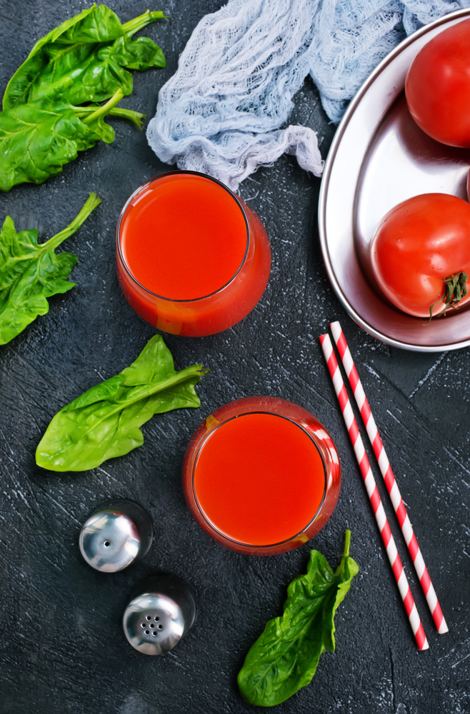 tomato juice in glass and on a table