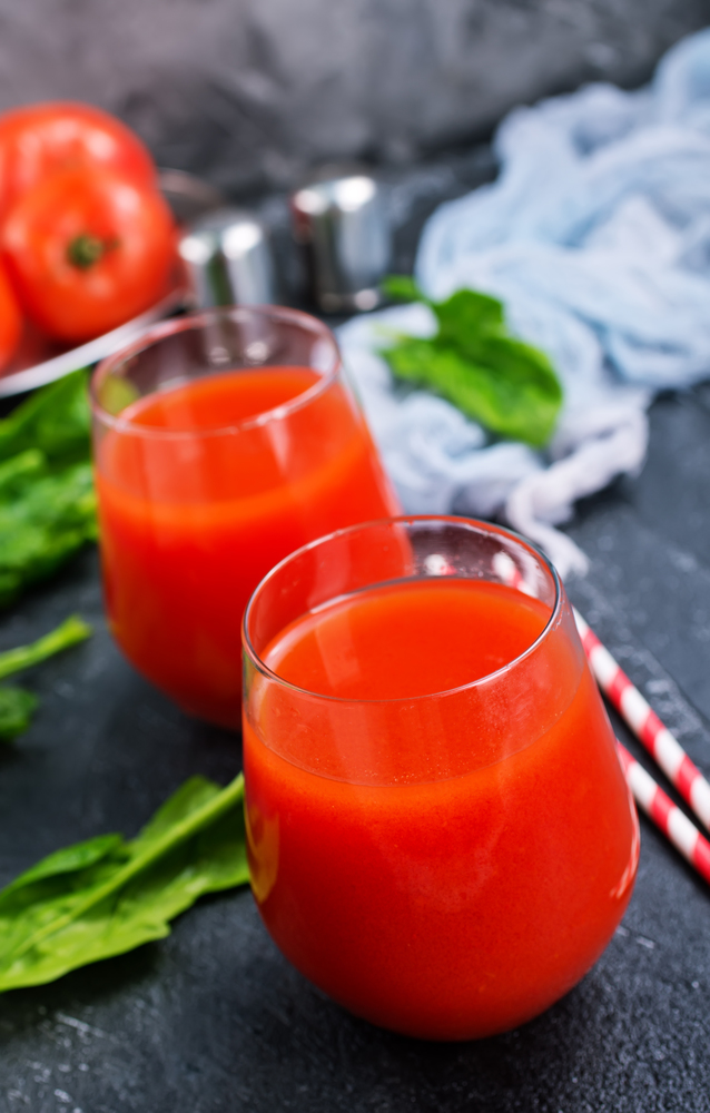 tomato juice in glass and on a table