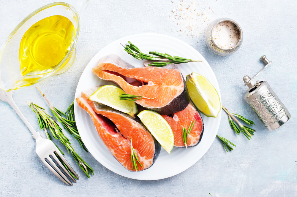 raw salmon steak with spice and oil
