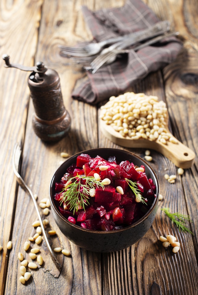 diet salad with boiled beet, beet salad with cedar nuts in bowl