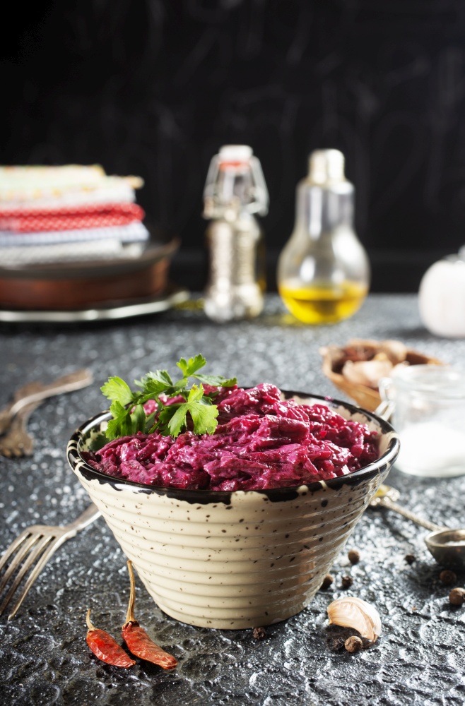 Salad of boiled beet. Beetroot salad with walnuts, eggs and sour cream in a bowl. Healthy food.