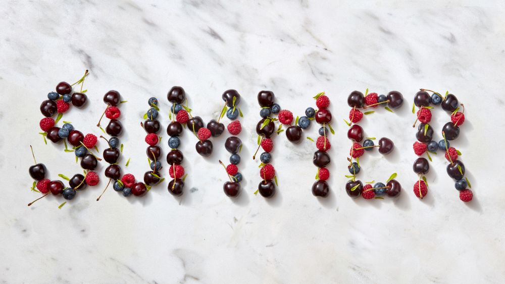 Word SUMMER made ripe sweet juicy red berries on gray stone background. Summer concept of healthy organic rood. Flat lay.. Summer background with summer berries - word "SUMMER" from cherry, raspberry, blueberries on gray stone background.