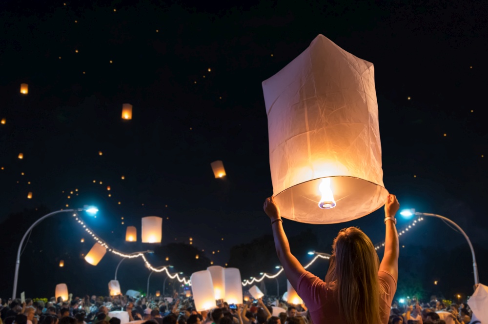 Women are releasing floating lanterns in the Loy Krathong festival or floating lanterns festival in Chiang Mai, Thailand.. Floating lanterns Festival