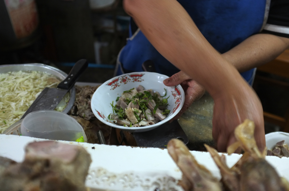 Chef cooking noodle with pork and pork entrails in local restaurant, Thailand street food at Sakon Nakhon , thailand .