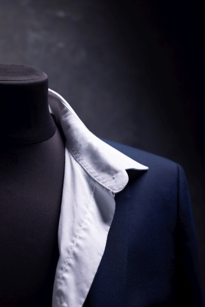 suit jacket and shirt on male tailor mannequin, creative concept of clothes atelier