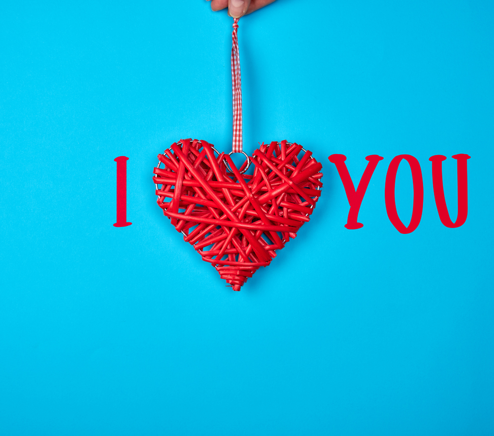 wicker red heart on a blue background, inscription i love you