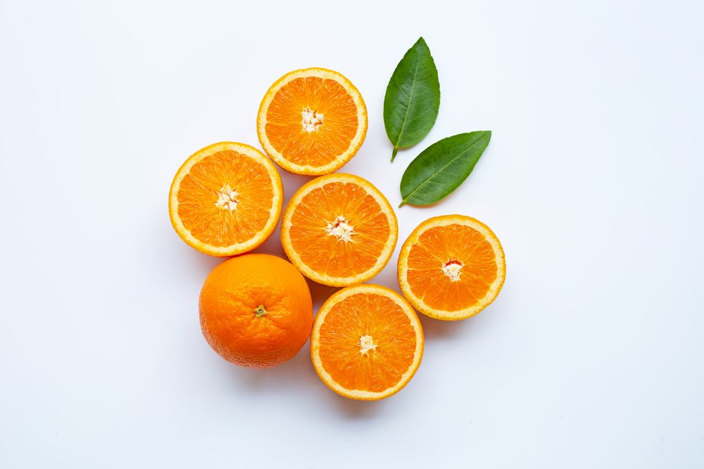 Fresh orange citrus fruit with leaves isolated on white background.  Top view