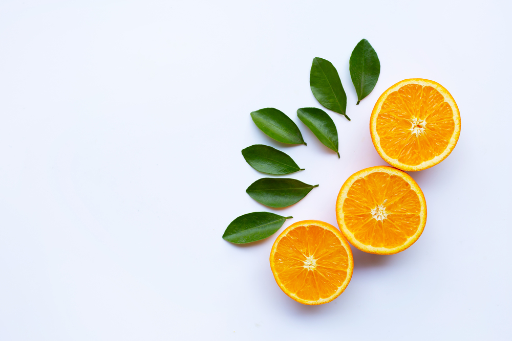 High vitamin C. Fresh orange citrus fruit with leaves isolated on white background. Copy space