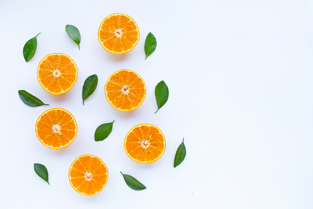 High vitamin C, Orange fruits with leaves on white background. Top view