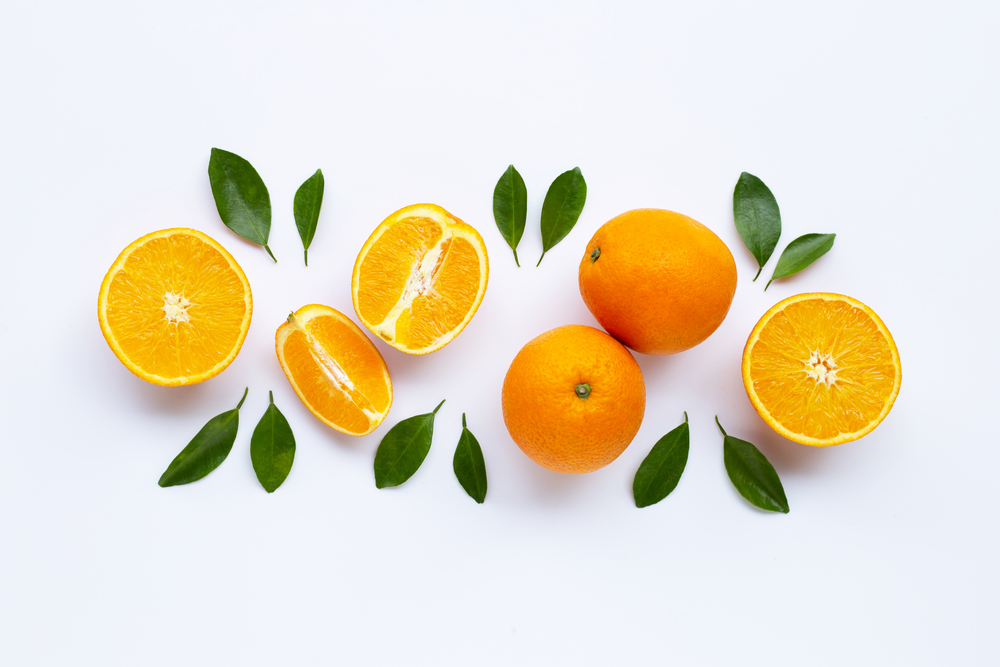 High vitamin C. Fresh orange citrus fruit with green  leaves isolated on white background.